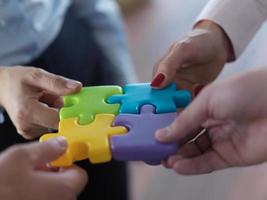 business people group assembling jigsaw puzzle photo