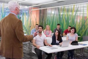 teacher with a group of students in classroom photo