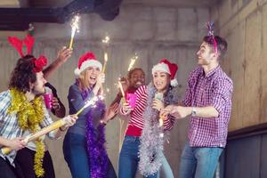 multiethnic group of casual business people dancing with sparklers photo