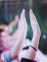 students group raise hands up on class photo