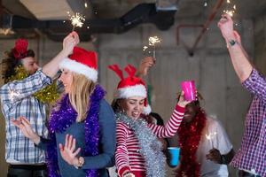 multiethnic group of casual business people dancing with sparklers photo