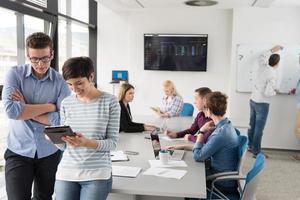 Two Business People Working With Tablet in office photo