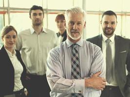 senior business man with his team at office photo