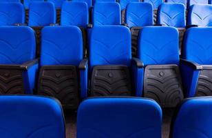 hall with rows of blue seats photo