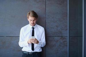 startup businessman in a white shirt with a tie using mobile phone photo