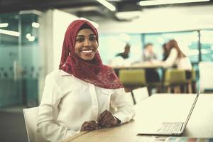 black muslim business woman ,working on laptop computer photo