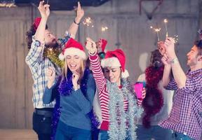 multiethnic group of casual business people dancing with sparklers photo