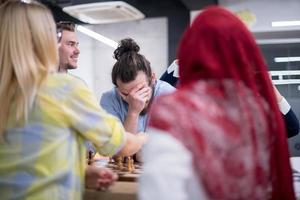 multiethnic group of business people playing chess photo