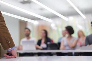 close up of teacher hand while teaching in classroom photo