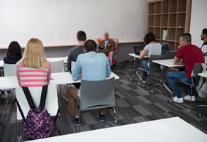 teacher with a group of students in classroom photo