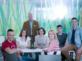 portrait of in teacher in classroom with students group in background photo