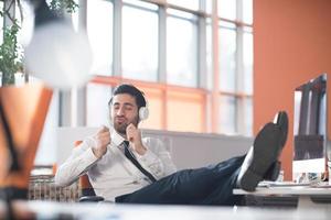 relaxed young business man at office photo