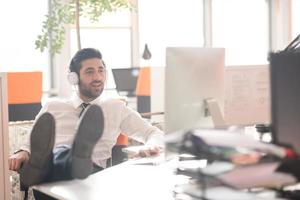 relaxed young business man at office photo