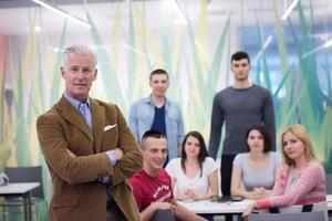 portrait of  teacher with students group in background photo