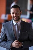 young business man portrait  at modern office photo