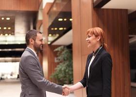 businesswoman and businessman handshake photo