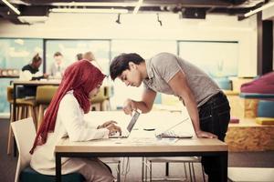 black muslim business woman having a meeting with her indian male colleague photo