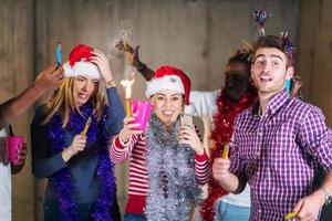 multiethnic group of casual business people dancing with sparklers photo