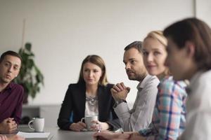 Group of young people meeting in startup office photo