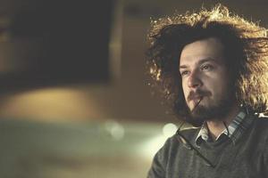 man working on computer in dark office photo