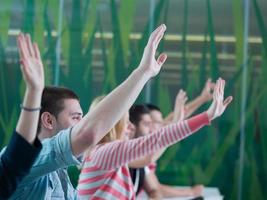 students group raise hands up on class photo