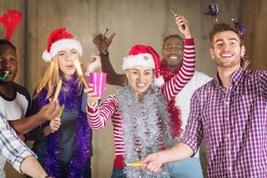 multiethnic group of casual business people dancing with sparklers photo