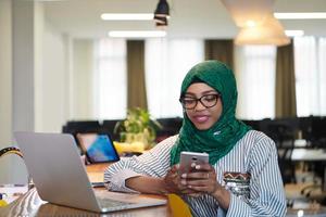 african muslim business woman using mobile phone photo