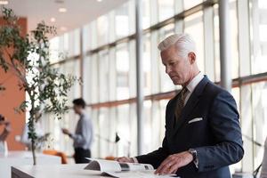 senior business man reading magazine photo