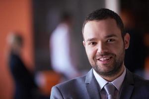 young business man portrait  at modern office photo