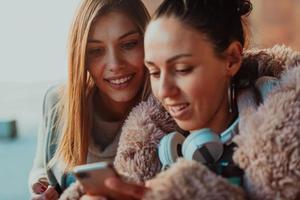 two friends stand in front of the university and use a smartphone photo