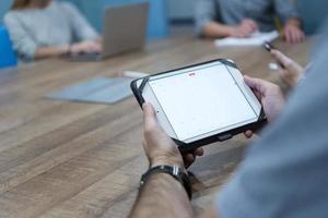 close up of businessman on meeting using tablet photo