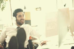 relaxed young business man at office photo