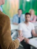 close up of teacher hand while teaching in classroom photo