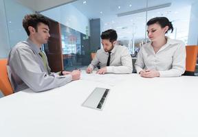 young couple signing contract documents on partners back photo