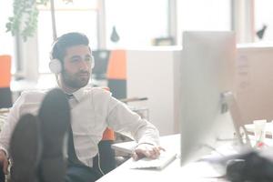 relaxed young business man at office photo