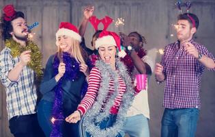 multiethnic group of casual business people dancing with sparklers photo