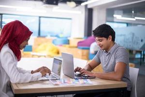 black muslim business woman having a meeting with her indian male colleague photo