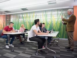 teacher with a group of students in classroom photo