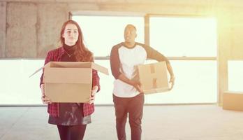 multiethnic business team carrying cardboard boxes photo