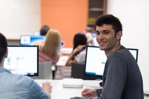 technology students group working  in computer lab school  classroom photo