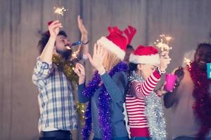 multiethnic group of casual business people dancing with sparklers photo