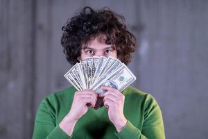 business man displaying a spread of american dollar cash money photo