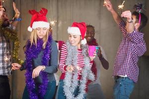 multiethnic group of casual business people dancing with sparklers photo