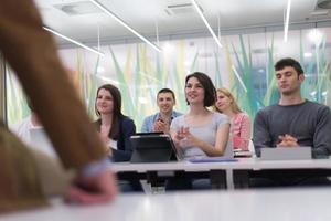 teacher with a group of students in classroom photo