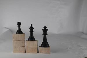 Chess pieces' from wooden cubes show the concepts of equity. Business concept photo