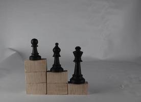 Chess pieces' from wooden cubes show the concepts of equity. Business concept photo