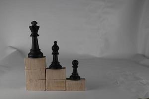 Chess pieces' from wooden cubes show the concepts of reality. Business concept photo