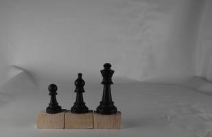 Chess pieces' from wooden cubes show the concepts of equality. Business concept photo