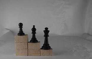 Chess pieces' from wooden cubes show the concepts of equity. Business concept photo