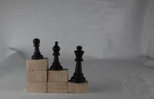 Chess pieces' from wooden cubes show the concepts of equity. Business concept photo